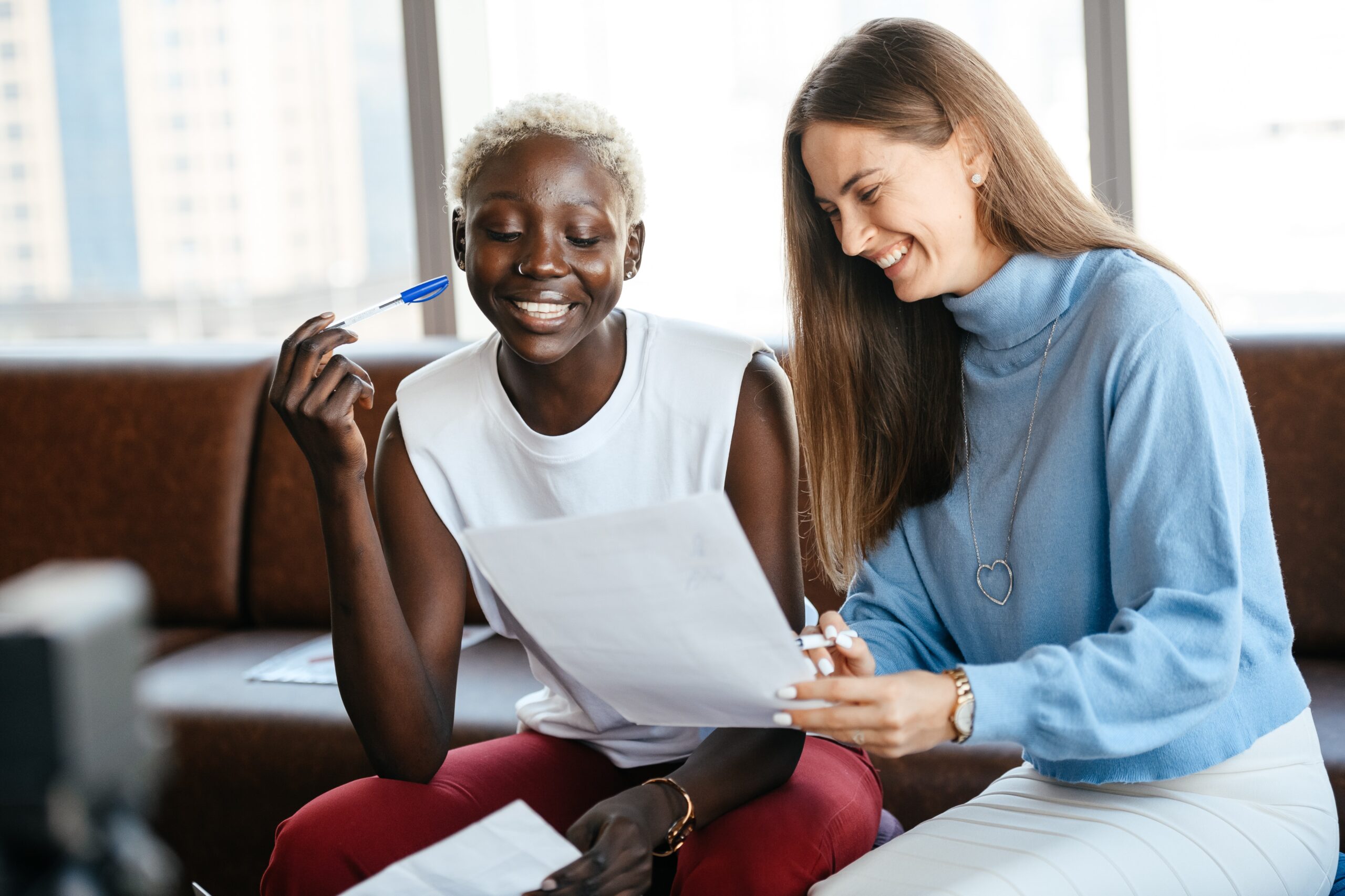 Office agents sitting down smiling discussing a lease