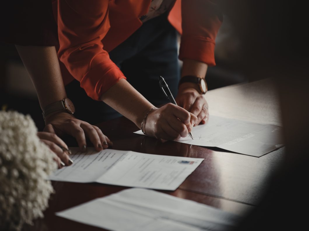 Photo of two people looking at documents.