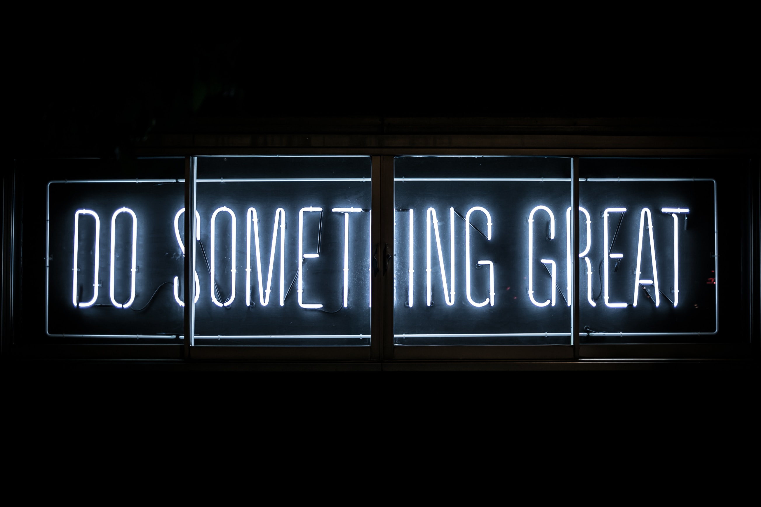 Neon sign saying "Do something great"