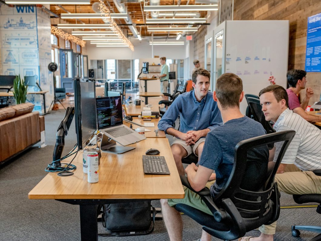 Employees collaborating in hot desking space